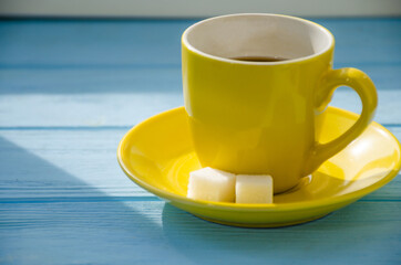 still life of cake with cup of coffee highlighted by sunlight