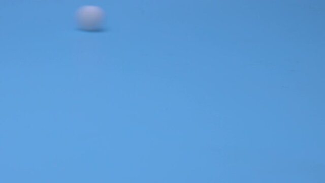 Pills roll across the table on a blue background. The concept of the medicine and addiction.