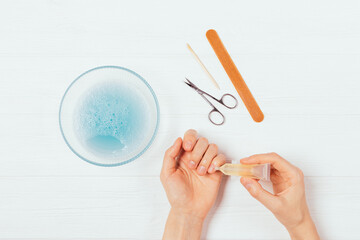 Female hands apply cuticle oil