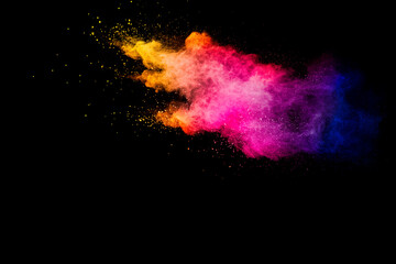 Explosion of multicolored powder isolated on black background.