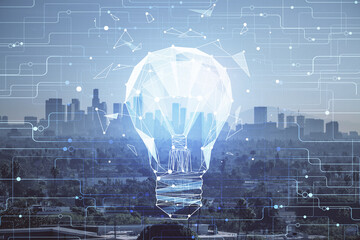Multi exposure of bulb hologram drawing and cityscape background. Concept of idea.