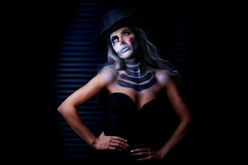 Fototapeta na wymiar Spooky portrait of woman in halloween gotic makeup