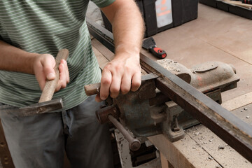 Male carpenter working on old wood in a retro vintage style.
