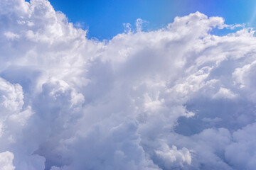 White clouds in blue sky. Aerial bird's eye clouds. Aerial top cloudscape. Texture of clouds. View from above.