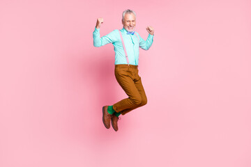 Full length body size side profile photo of smiling elder man jumping high wearing retro clothes isolated on pink color background