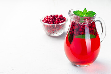 Lingonberry and lime punch or limeade in glass jar, horizontal, copy space