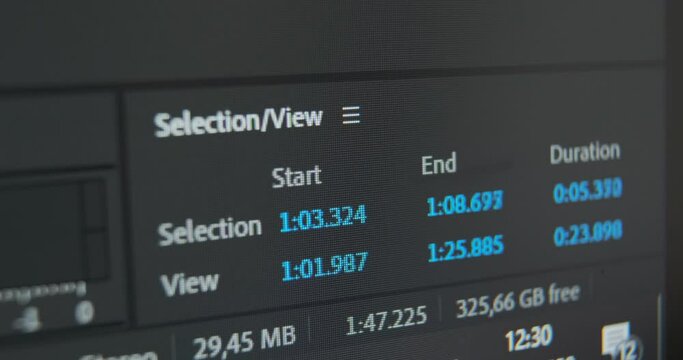Small blue digits change on panel displaying duration and end of footage on timeline at editing project in computer program macro view