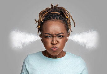 Mad young black lady with steam coming out of ears