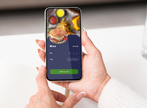 Fast food delivery to work in office or home during pandemic. Hands of business woman holding smartphone - Powered by Adobe