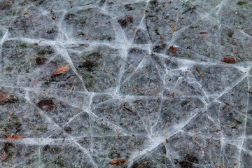 layer of ice cracked on the surface of a field