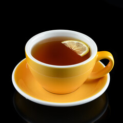 hot tea with lemon on a black background