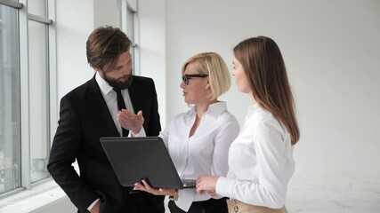 Real Estate Agent Shows Stylish Modern office to a Beautiful Young Couple who are Interested in Purchasing/ Buying/ Renting. - Powered by Adobe