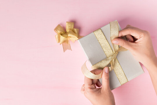 Premium Photo  Small gift box with bow pink and silver ribbon for gift  wrapping on pink background