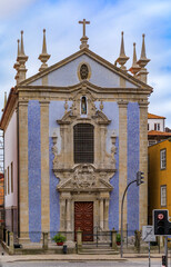 Fototapeta na wymiar Traditional houses and Parish Church of St. Nicholas with ornate Portuguese azulejo tiles in Ribeira in Porto, Portugal