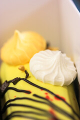 French, beautifully decorated eclairs with cream filling and meringue and caramel, breakfast in a luxurious cafe.