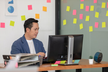 Asian senior business man in casual working with laptop in modern office or co-working space,Business Startup Concept