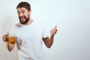 man with a mug of beer in his hands and a white t-shirt light background mustache beard emotions model