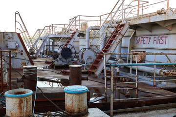 Fragment of old rusty barge (ship)