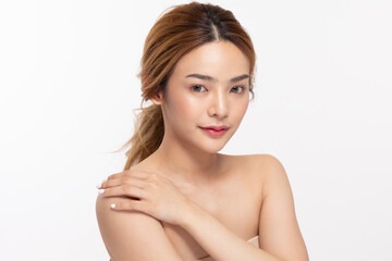 Obraz na płótnie Canvas Beautiful Young Asian Woman Looking While Touching Shoulder feeling so happy and cheerful with healthy Clean and Fresh skin,isolated on white background,Beauty Cosmetology Concept