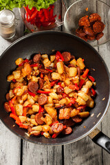 Tortilla de patatas. Cooking spanish omelette with sausage chori