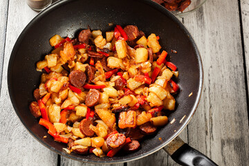 Tortilla de patatas. Cooking spanish omelette with sausage chori