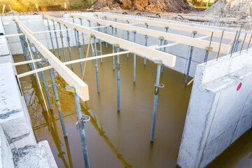Construction site with flooded foundation for house