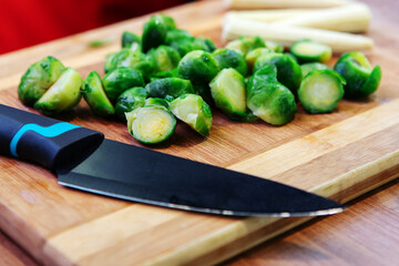 Chopped Brussels sprouts on a cutting board. Cooking healthy food from vegetables. Close-up