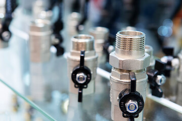 Chrome fittings for water supply installation. Trading parts in a plumbing store