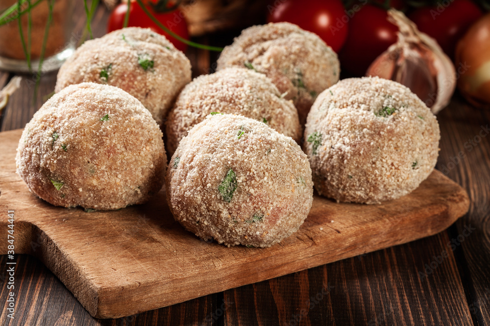 Poster Raw meatballs rolled in a crispy bun prepared for baking