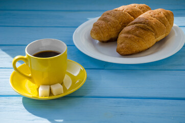 still life of cake with cup of coffee highlighted by sunlight