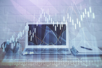 Financial graph colorful drawing and table with computer on background. Double exposure. Concept of...