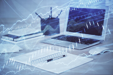 Stock market graph and table with computer background. Multi exposure. Concept of financial analysis.