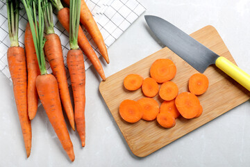 Flat lay composition with ripe carrots on light grey marble table