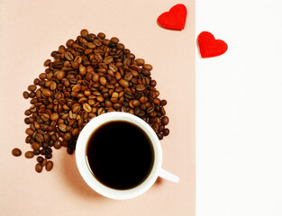  Cup of hot coffee on a pink background, coffee beans, two red hearts