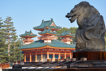 Naklejka premium Dragon statue over water ablution basin with Byakko-ro Tower of Heian-jingu Shrine. Kyoto. Japan