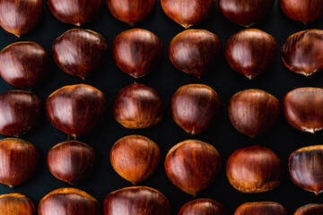 Rows of chestnuts isolated on black background