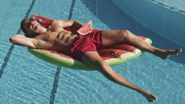 Good Looking Guy Floating In Swimming Pool