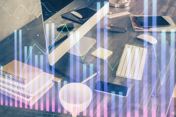 Double exposure of graph and financial info and work space with computer background. Concept of international online trading.