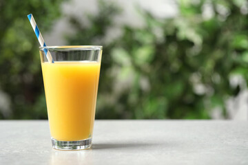 Glass of orange juice on light table. Space for text