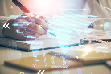 Multi exposure of hands making notes with world map hologram and data theme icons. Concept of global data.