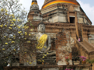 Ayutthaya, Thailand, January 24, 2013: Stone Buddha under a stupa in Ayutthaya, former capital of the kingdom of Siam. Thailand