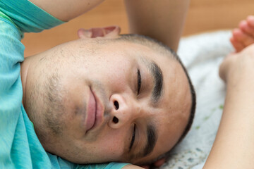 Obraz na płótnie Canvas cute young man sleeping on the bed
