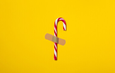 candy cane plastered to the yellow background