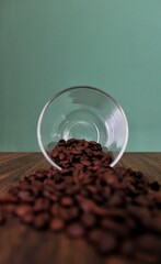 Coffee beans getting out from a coffee cup 