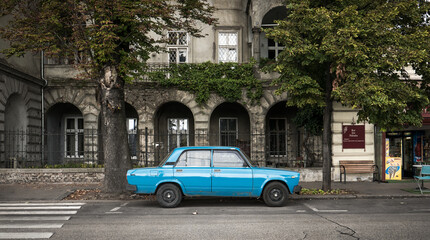 old car with old building in background in budapest