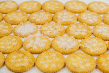 Spread of round cracker with sweet sugar isolated on white background