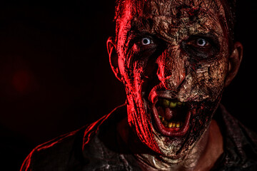 Scary zombie on dark background, closeup. Halloween monster