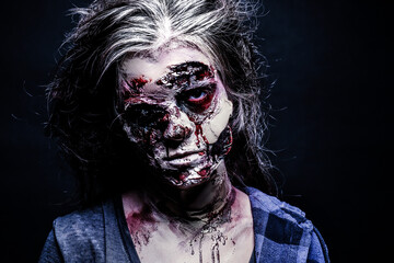 Scary zombie on dark background. Halloween monster