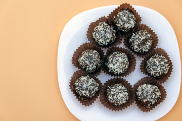 Mini cake petits fours  with coconut cream filling. Mini cake in a white plate. Selective focus. Place for text.