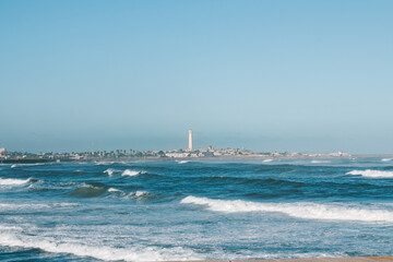 Wavy Atlantic Ocean view with lighthouse in Casablanca, Morocco, North Africa